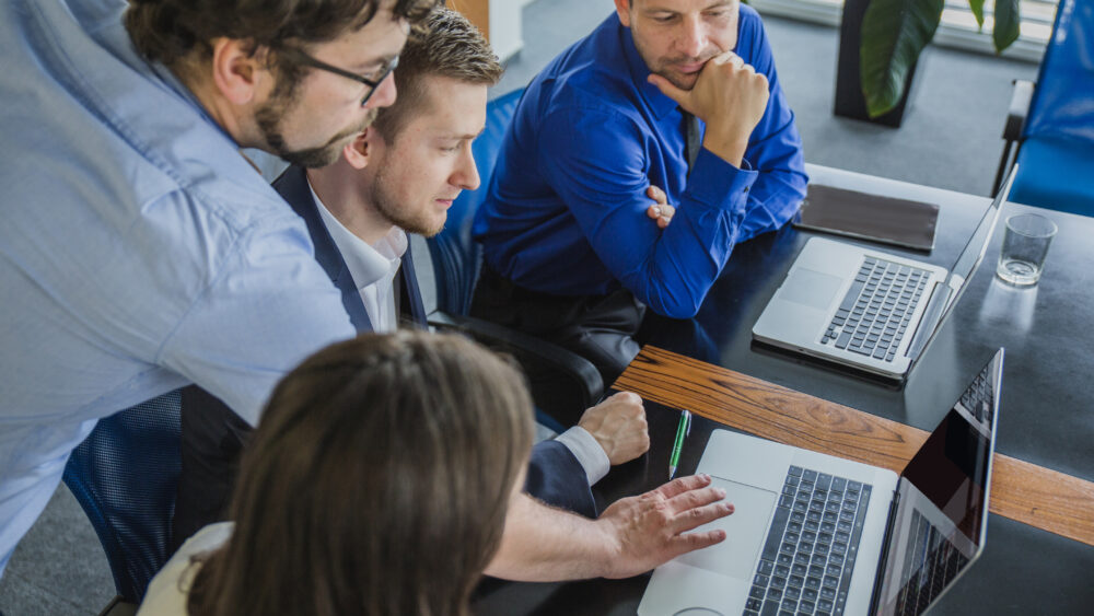 A group of IT officers discussing their legacy it system